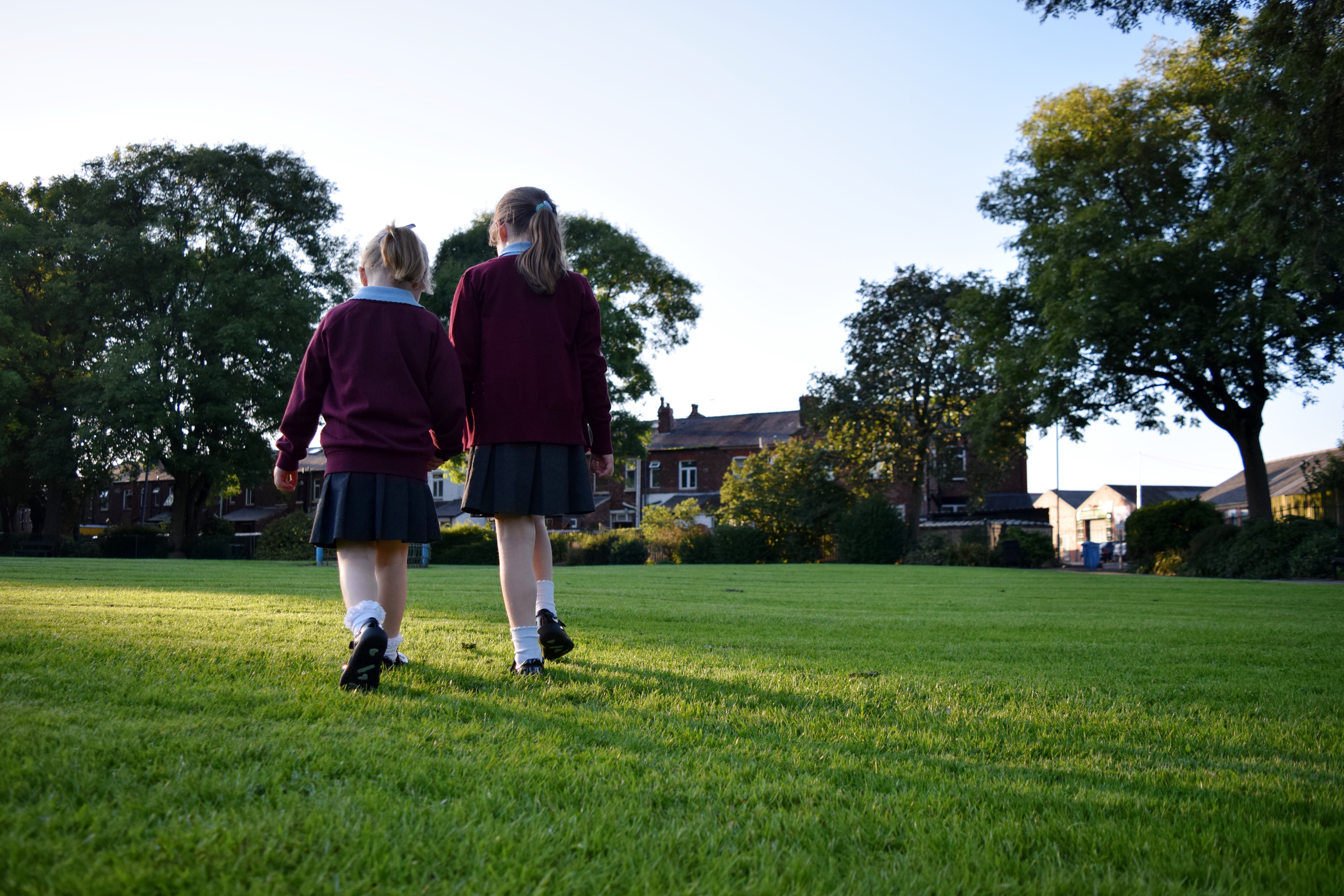 Children in school uniform walking away