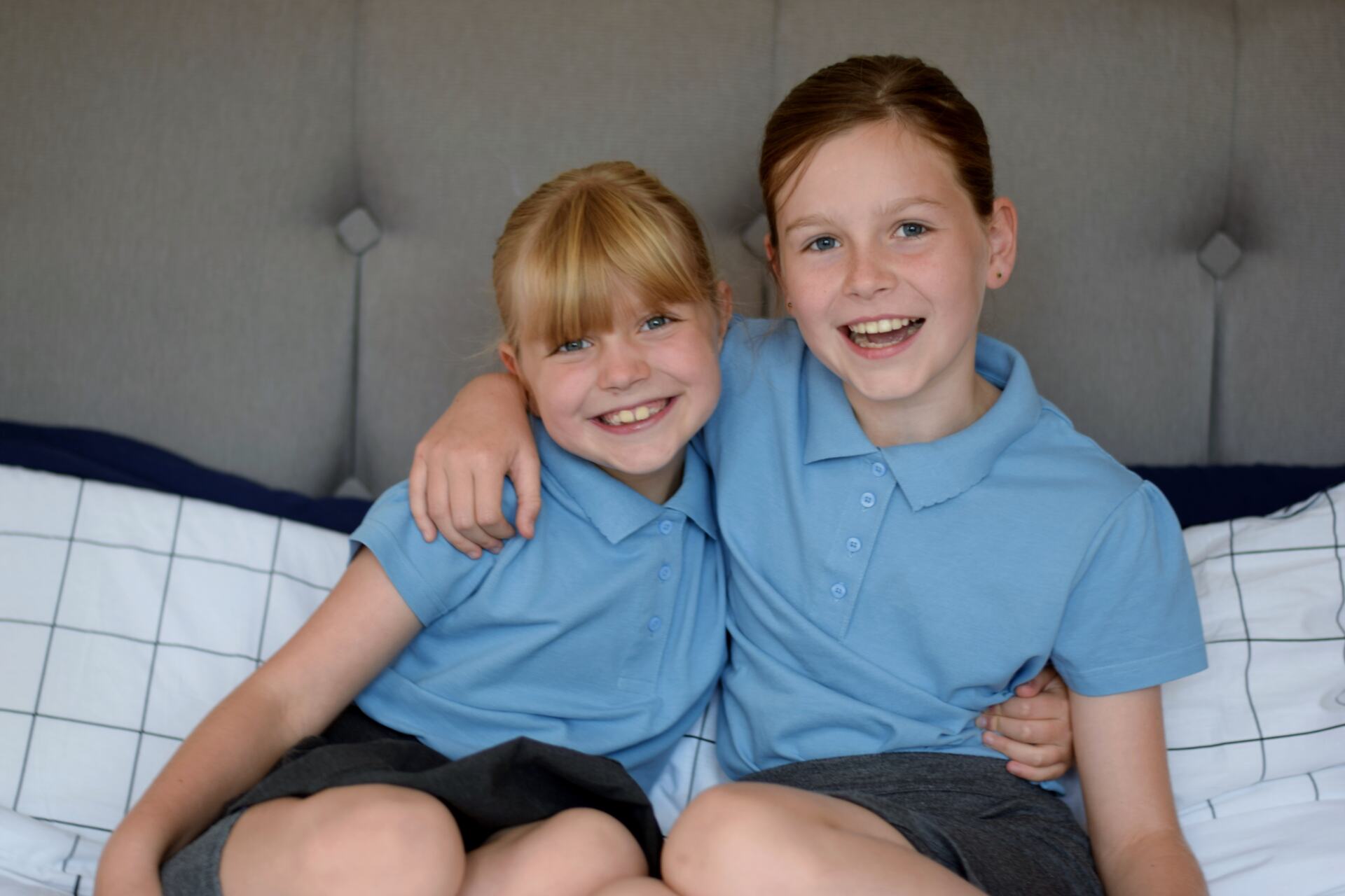 Chloe and Amy wearing their school uniform